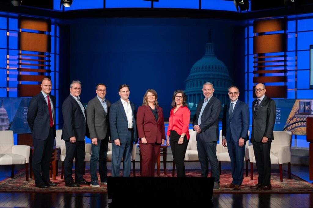 A group of individuals pose for a photograph while on stage at the Cybersecurity Stronger Together 2025 conference.